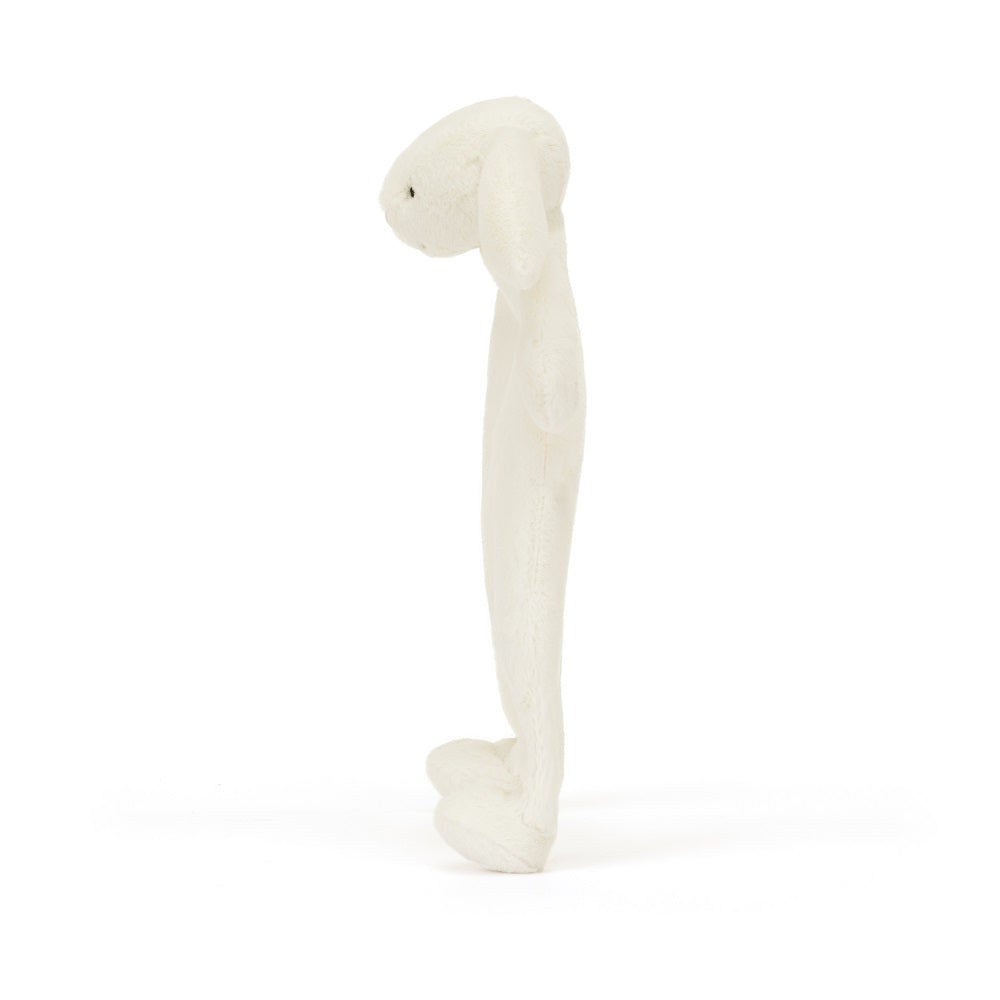 Side view of a white, plush rabbit toy.