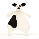 Stuffed white dog toy with black spots.