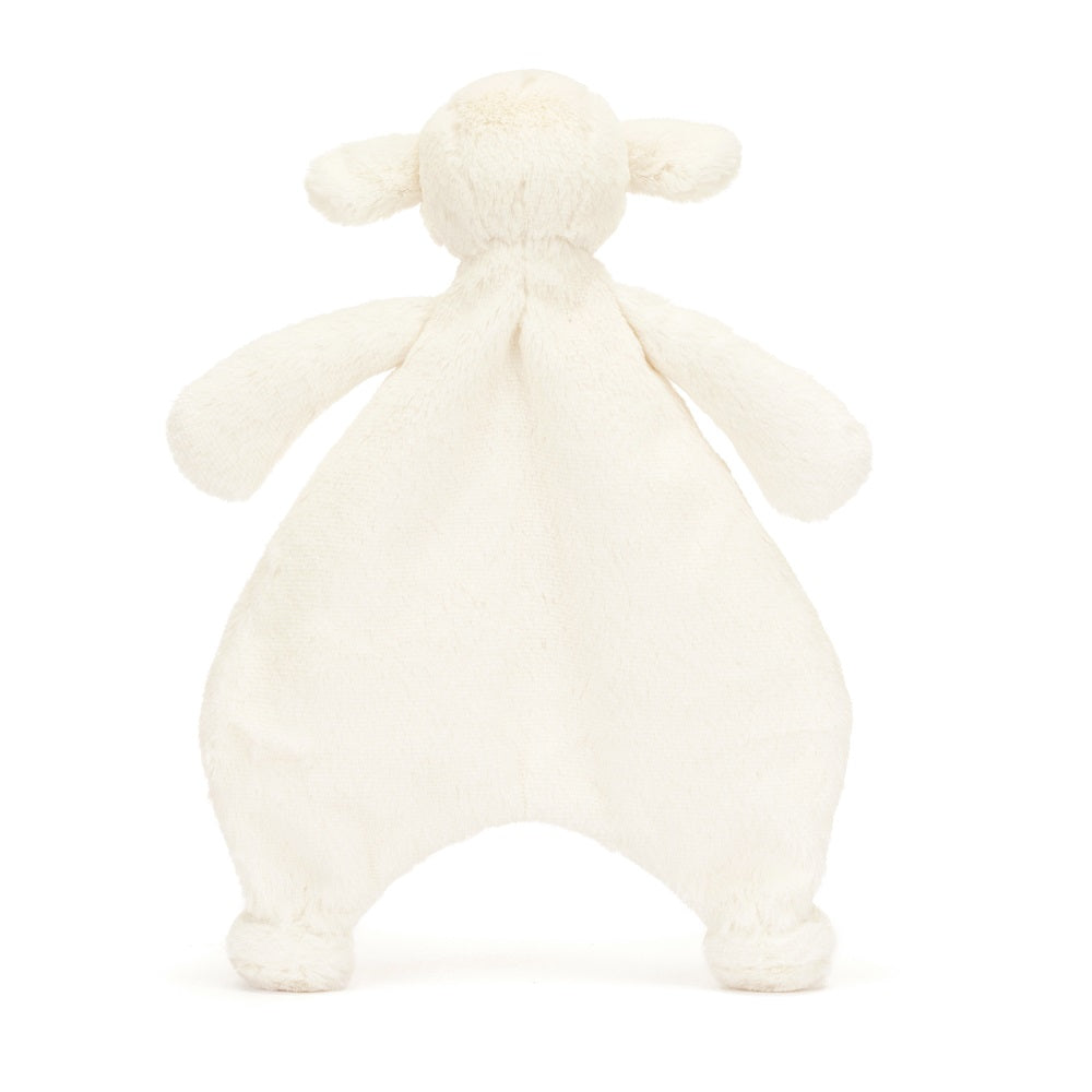 Cream-colored plush lamb toy.