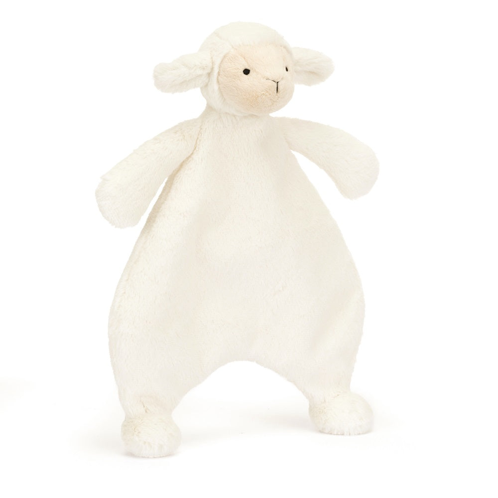 A cream-colored, plush lamb toy standing upright.