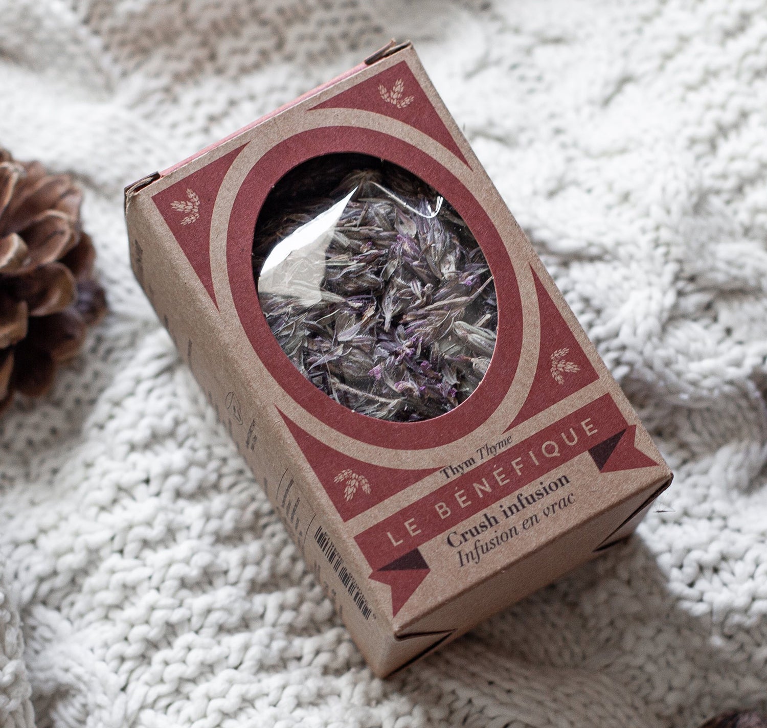 Box of herbal tea on a knitted blanket.