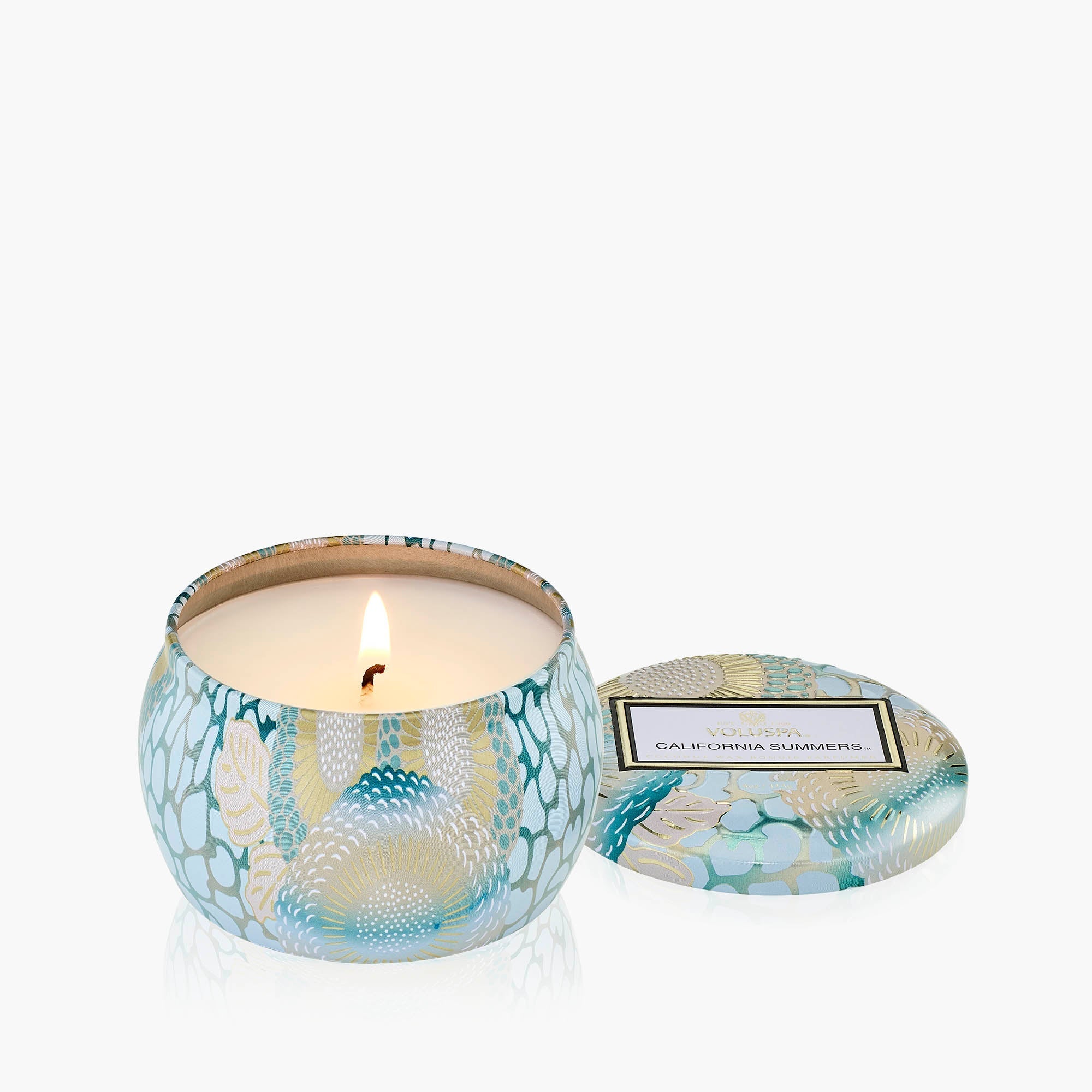 Candle in a decorative container with 'California Summers' label on a white background