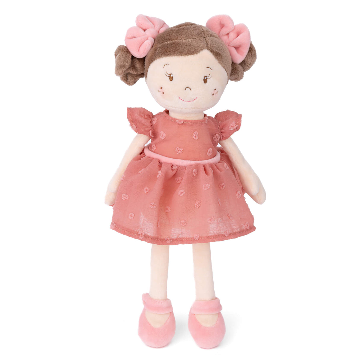 Stuffed doll with a pink dress and hair bows on a white background