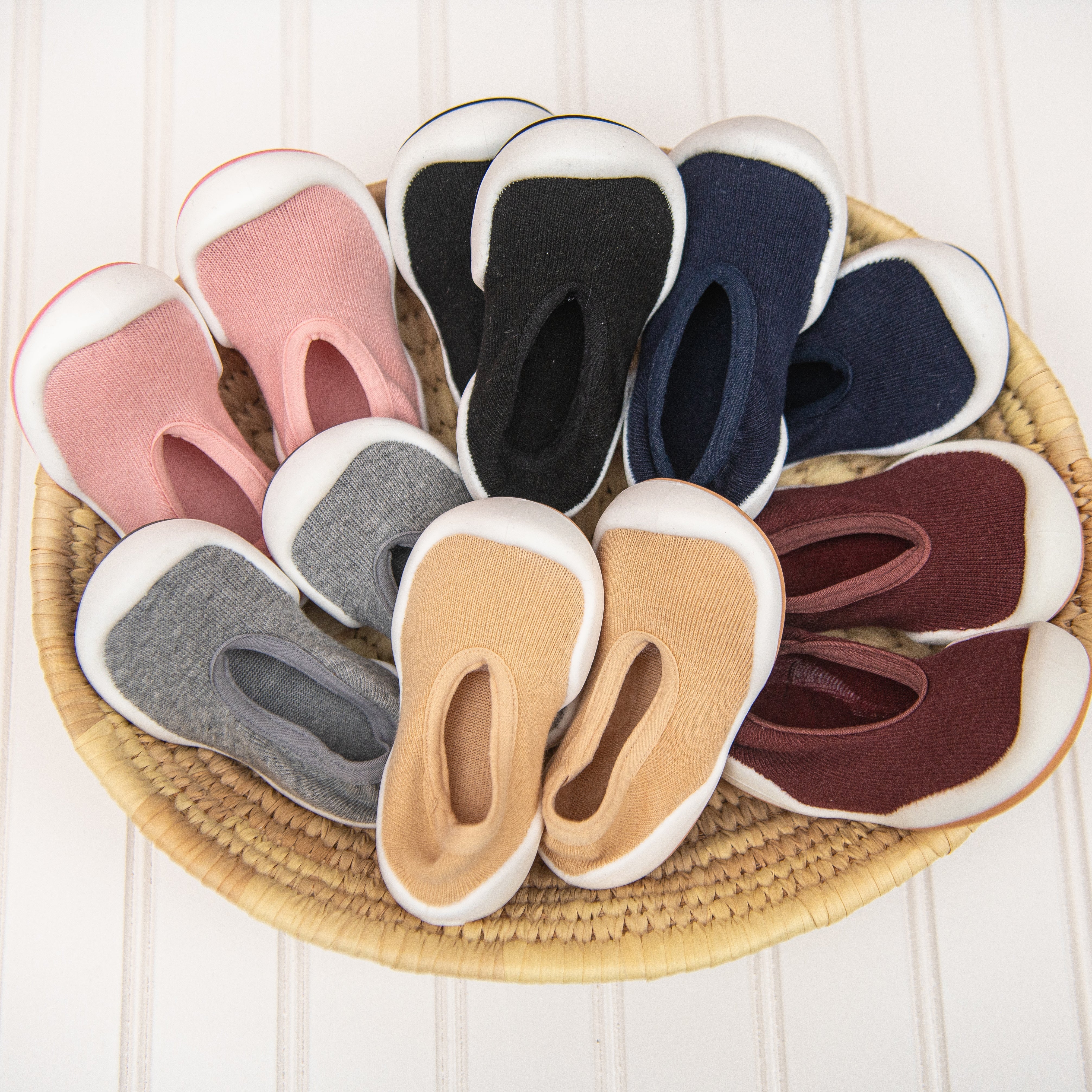 Basket of multi-colored baby slipper socks.