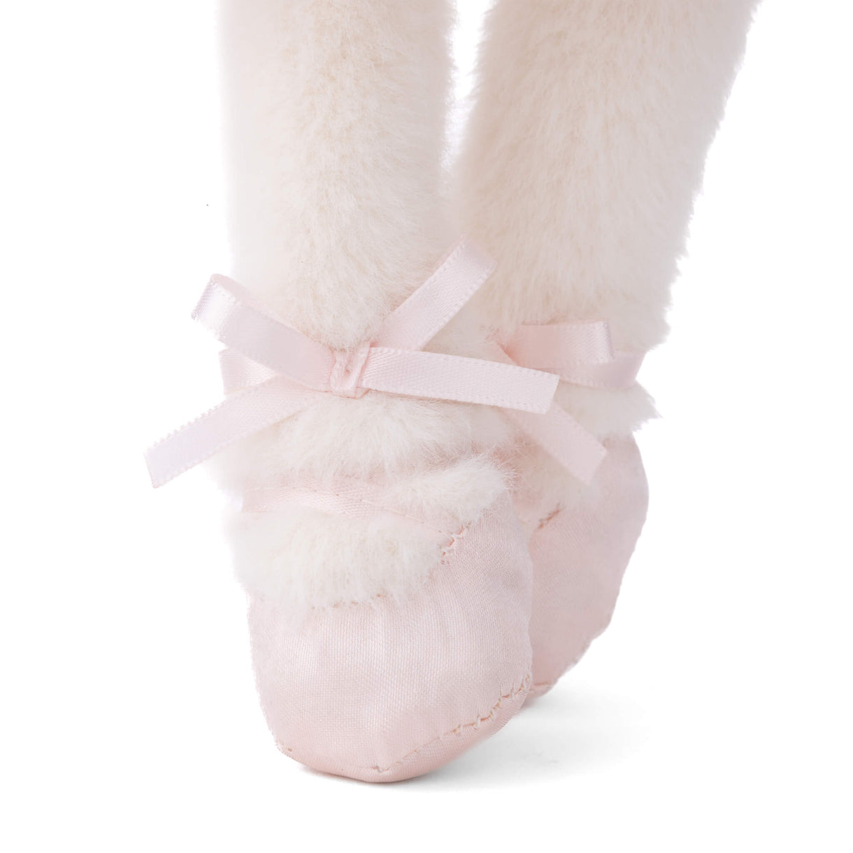 Pink ballet slipper with a bow on a white background