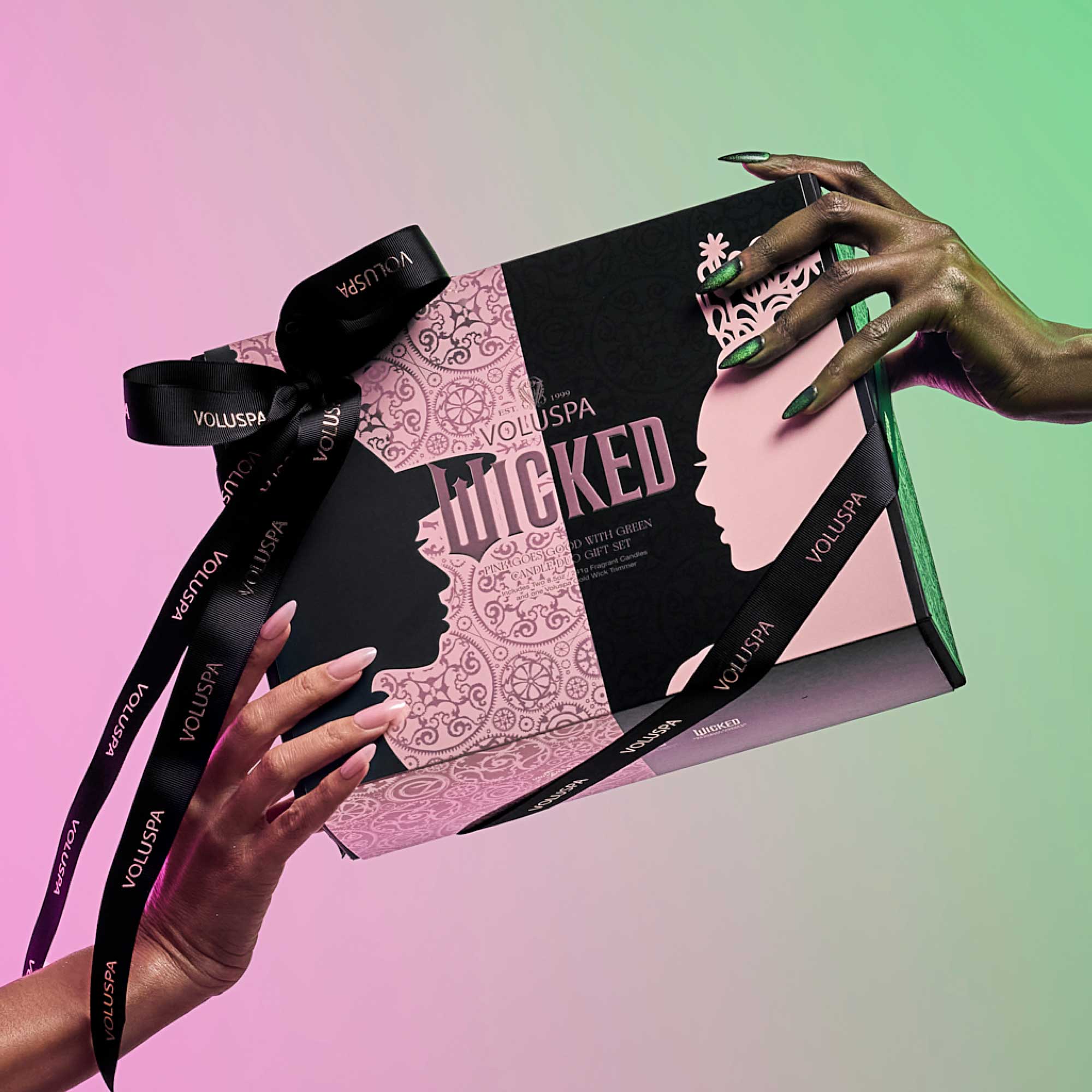 VOLUSPA 'Wicked' gift set with hands holding it against a gradient background