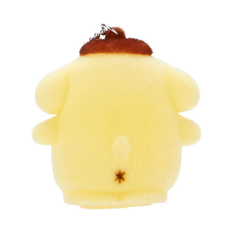 Close-up of the back of a yellow Pom Pom Purin plush keychain with a brown beret.