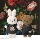 Crocheted bunny and bear in front of a floral painting.