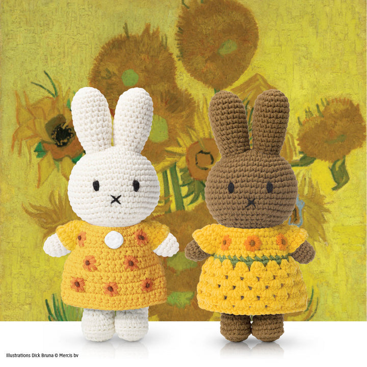 Two crocheted Miffy bunnies in yellow dresses against a backdrop of Van Gogh's sunflowers.
