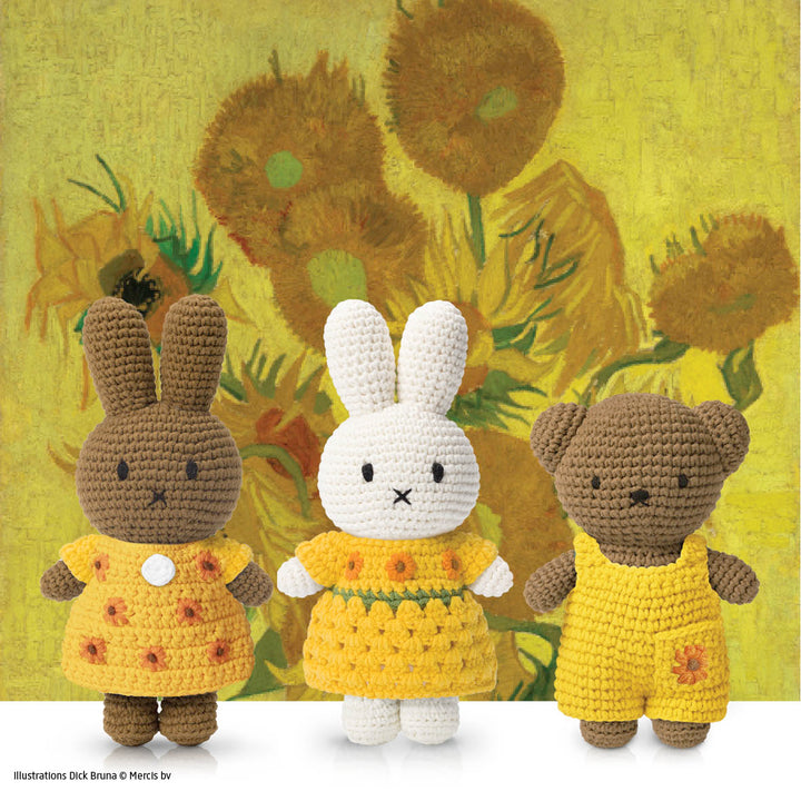 Crocheted stuffed animals against a backdrop of Van Gogh's sunflowers. A brown bunny, white bunny, and brown bear. All are in yellow clothing with sunflower details.
