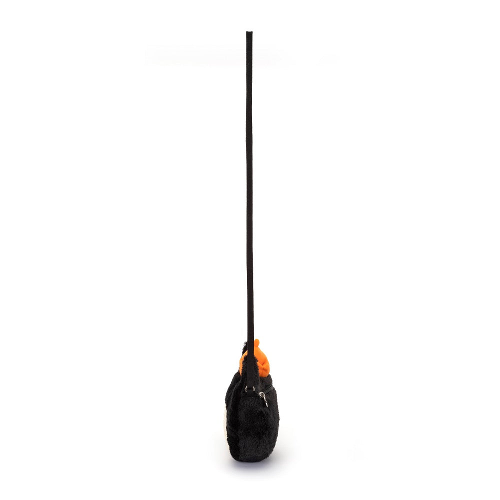 Black fuzzy drawstring bag with orange accents.