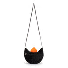 Black furry shoulder bag with orange object inside.