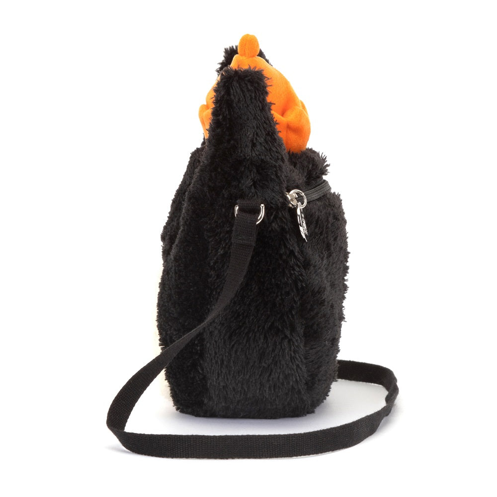 Black faux fur purse with orange lining and crossbody strap.