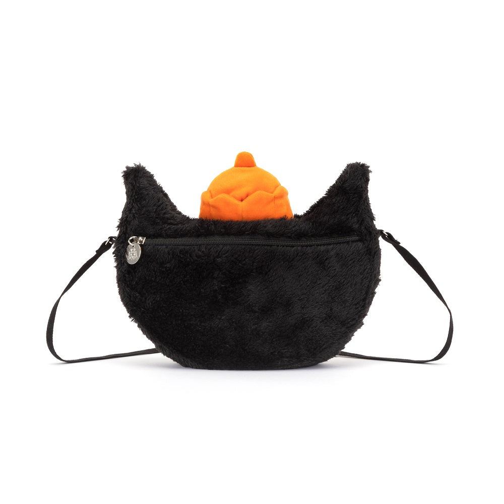 Black, fuzzy handbag with a small orange pumpkin.