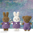 Crochet Miffy bunnies and bear, purple outfits, Monet's water lilies background.