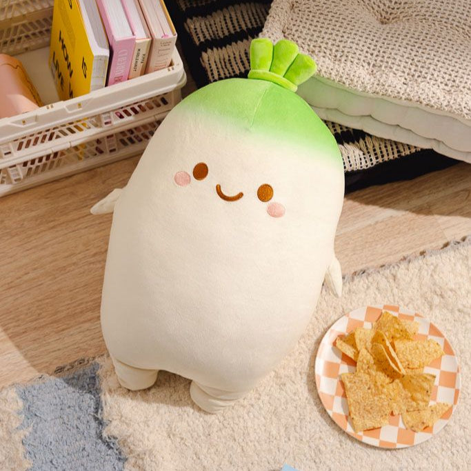 A plush radish with a smiling face next to a plate of nachos.