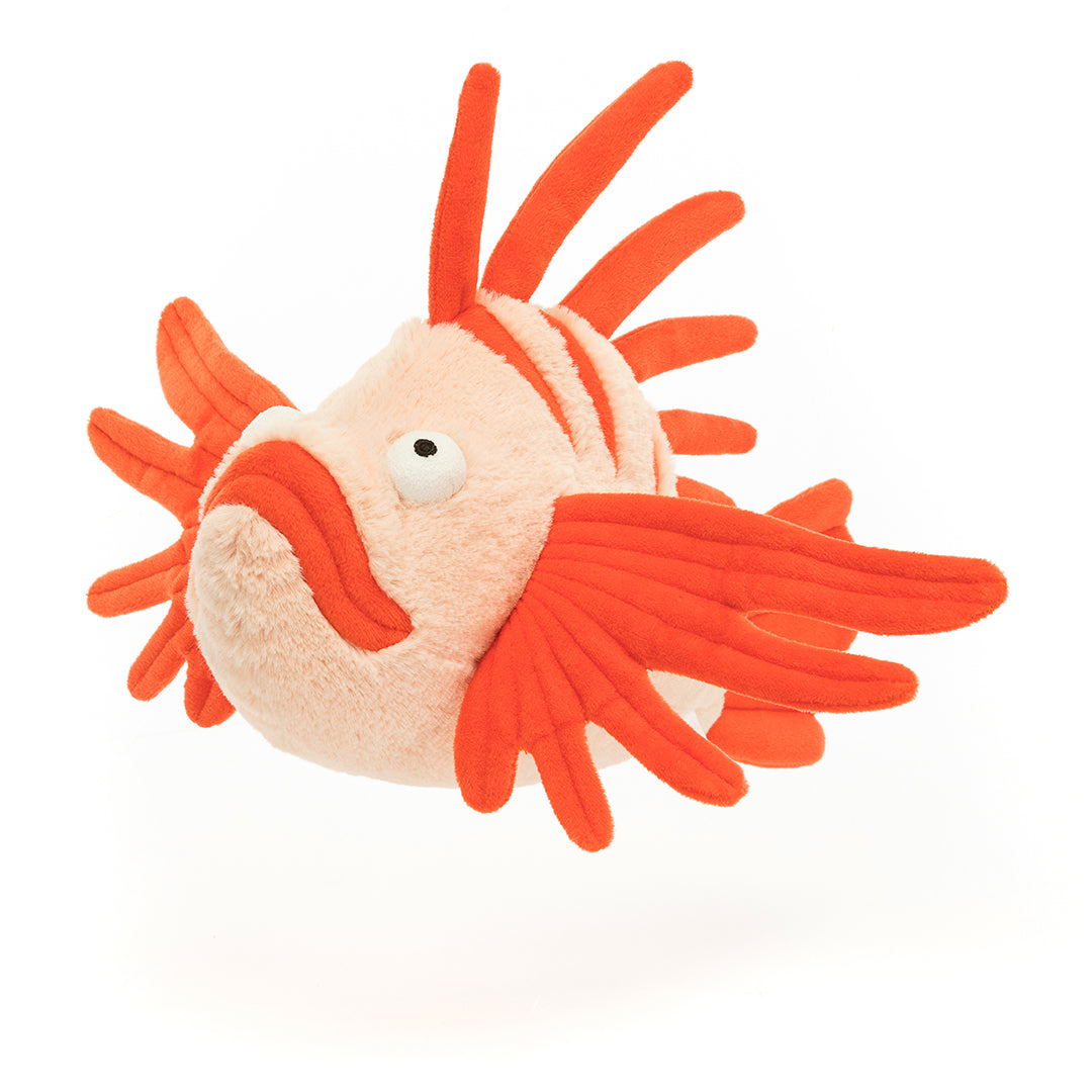 Stuffed orange lionfish on white background.