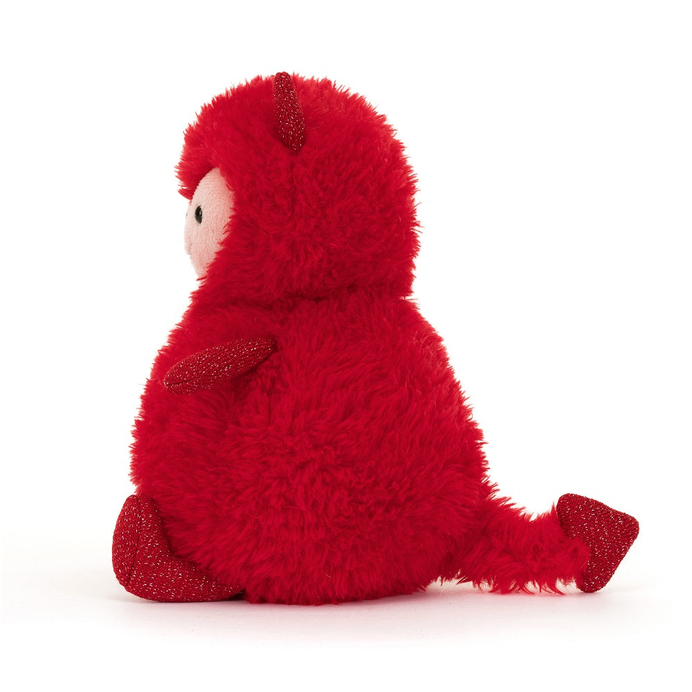 Red, furry, seated, plush toy devil with horns and a tail.