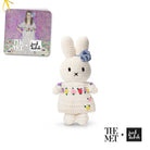 Crocheted rabbit toy with floral dress, tag with painted image.