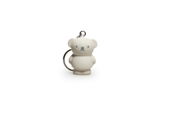 A gray bear-shaped keychain with a metal ring.