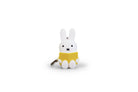 White Miffy bunny keychain, reading a yellow book.
