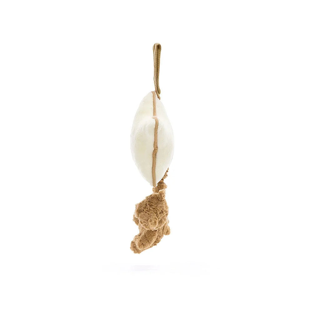 Hanging cream and brown plush toy.