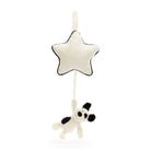 Stuffed white star with black trim hanging above stuffed white and black cow.