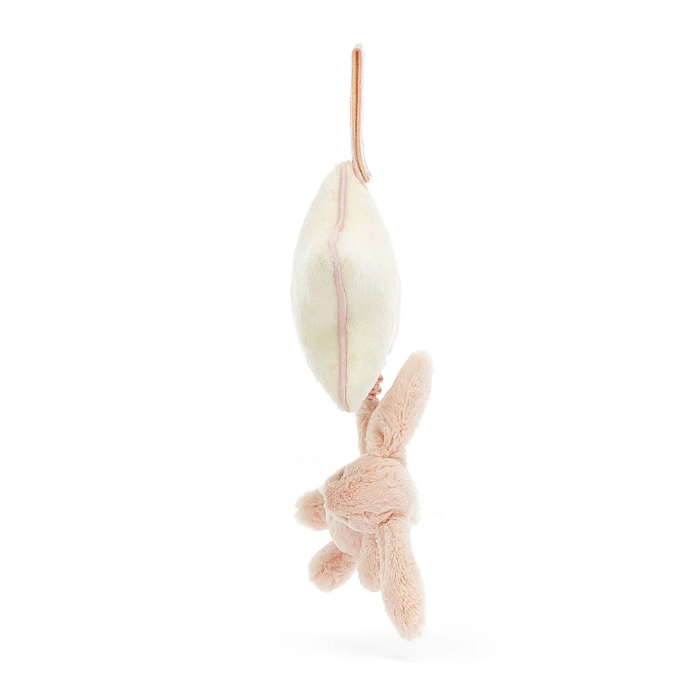 Hanging plush bunny with cream cushion.