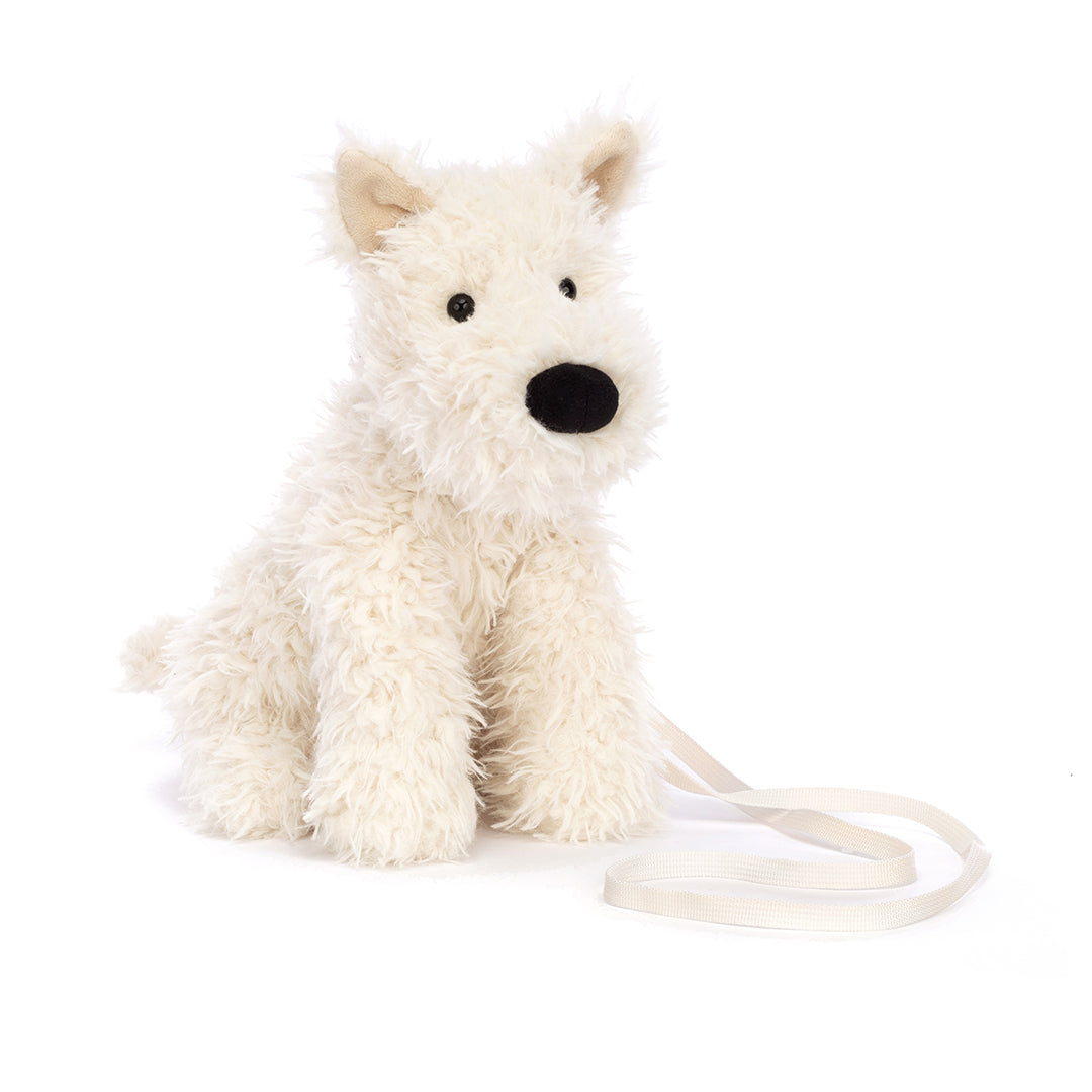 Stuffed, fluffy, white West Highland terrier puppy with a black nose and white leash.