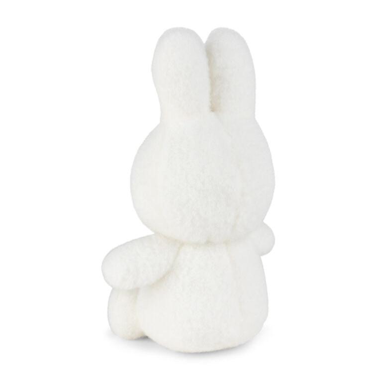 Back view of a white, fuzzy bunny stuffed animal.