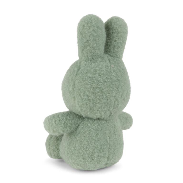 Rear view of a sage green stuffed bunny.