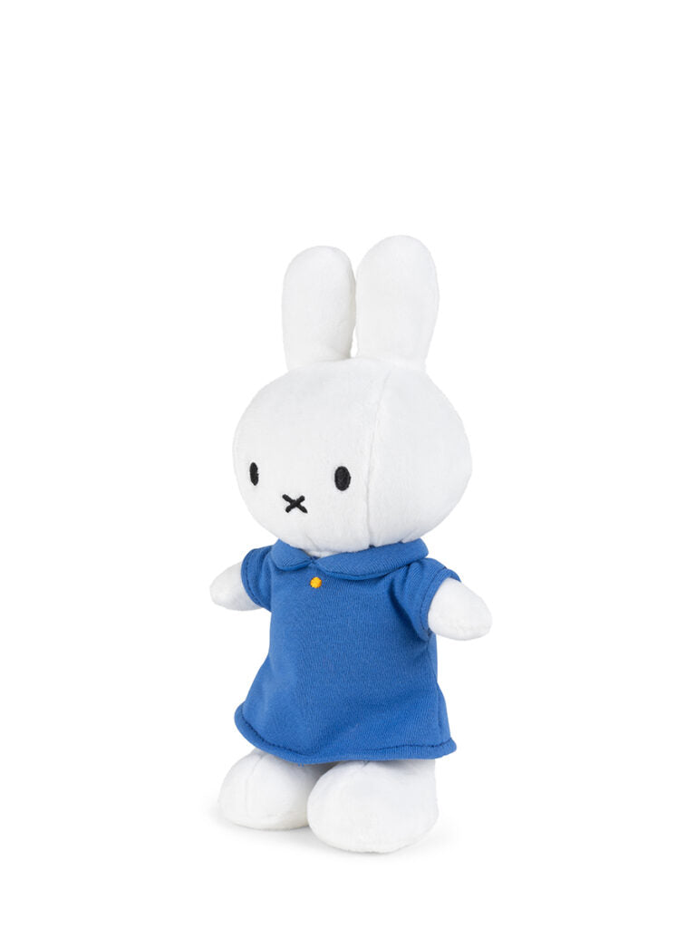 Stuffed white Miffy rabbit in a blue dress.