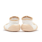 Pair of toddler sock shoes, white with tan trim.
