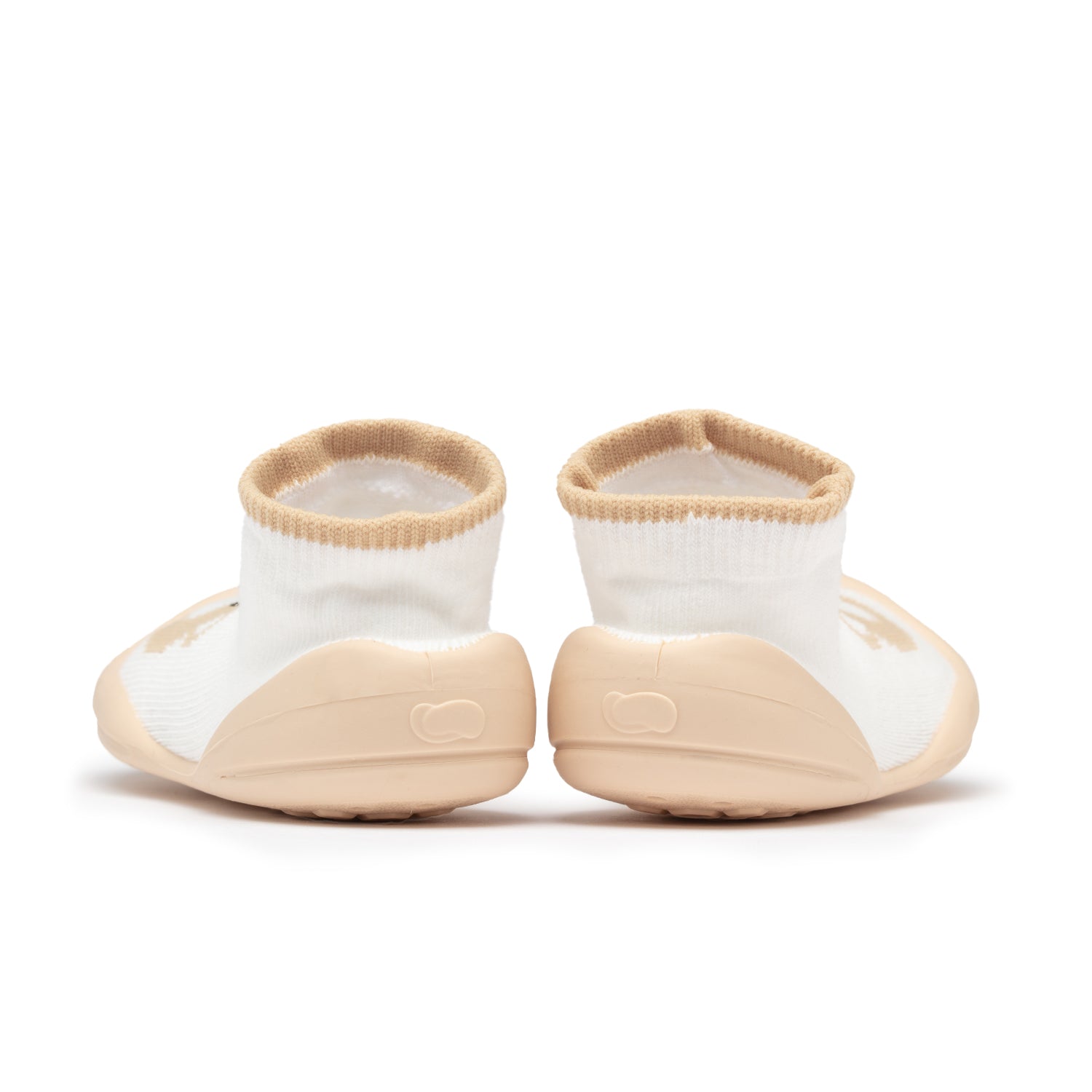 Pair of toddler sock shoes, white with tan trim.