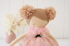 Tan fabric doll with pink tulle dress and yarn pom-poms for hair.