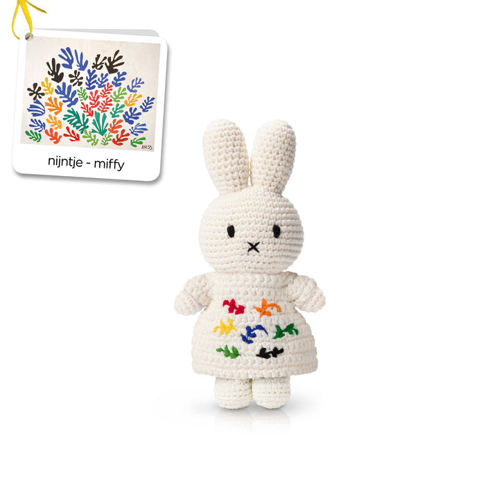 Crocheted Miffy doll in white dress with colorful embroidery, displayed with image of Matisse artwork.