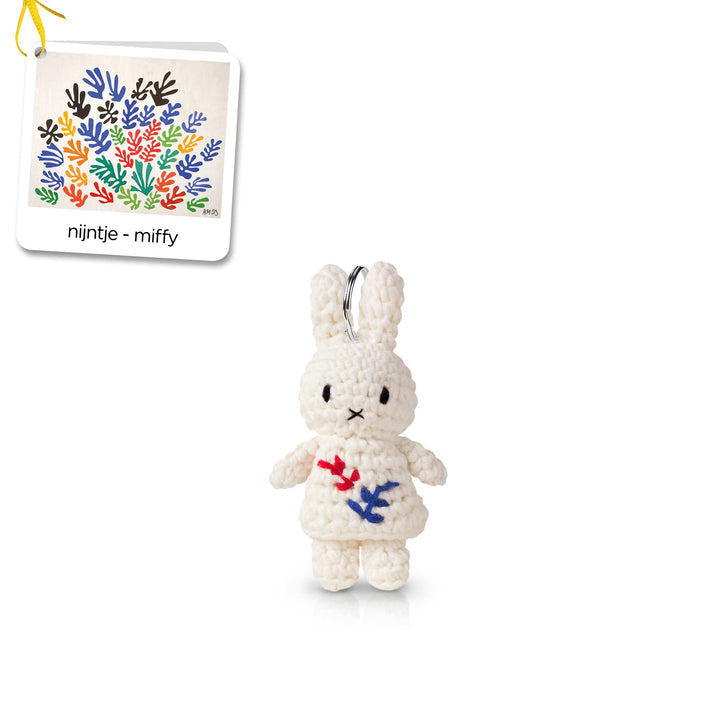 Crocheted Miffy keychain with floral embroidery.