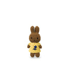 Crocheted brown rabbit in a yellow dress with blue flower detail.