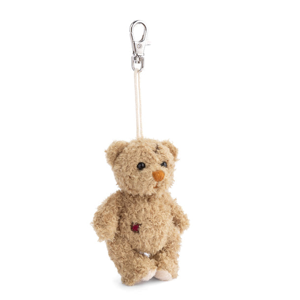 Small teddy bear keychain with a red heart on a white background