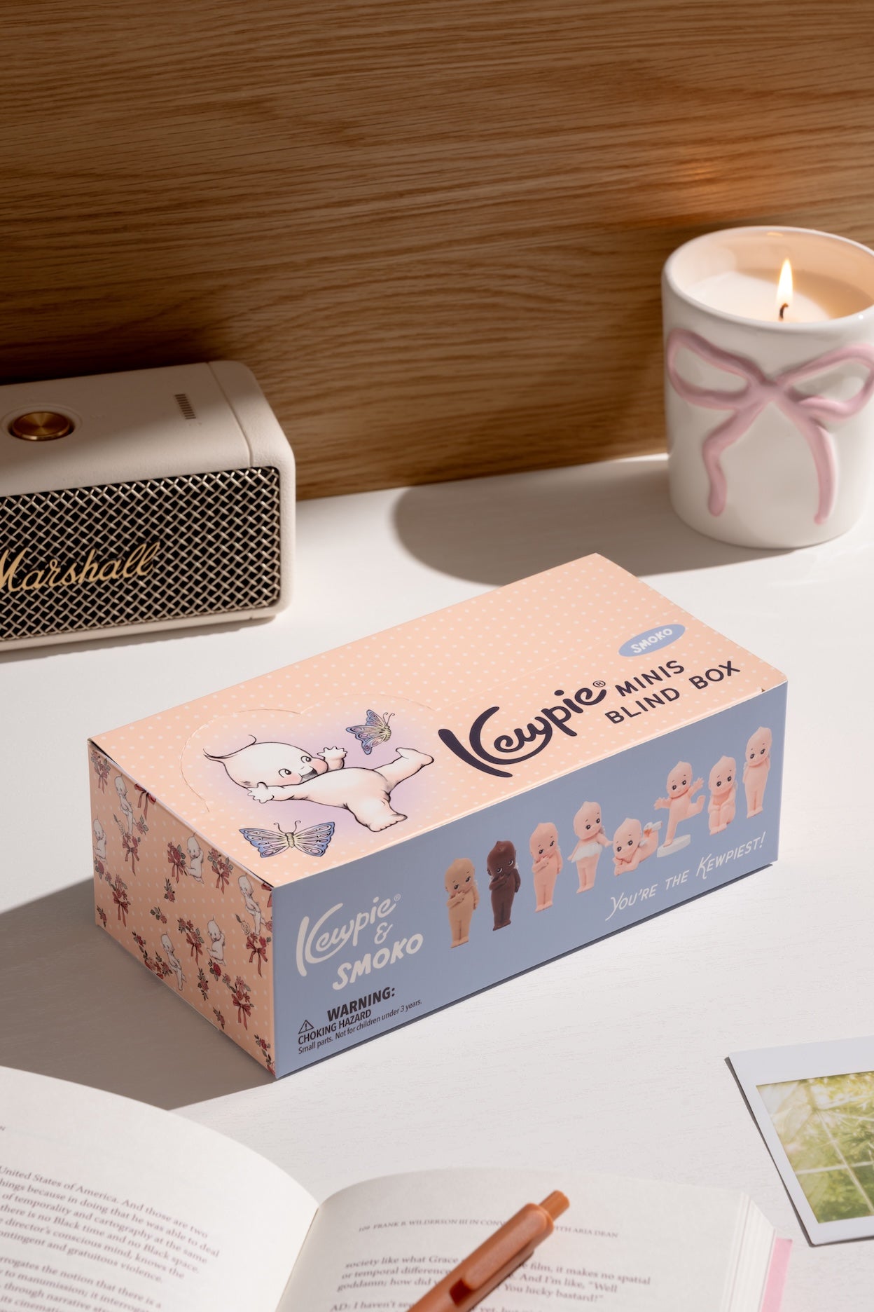 Keypie mini blind box on a table with a candle and Marshall speaker in the background