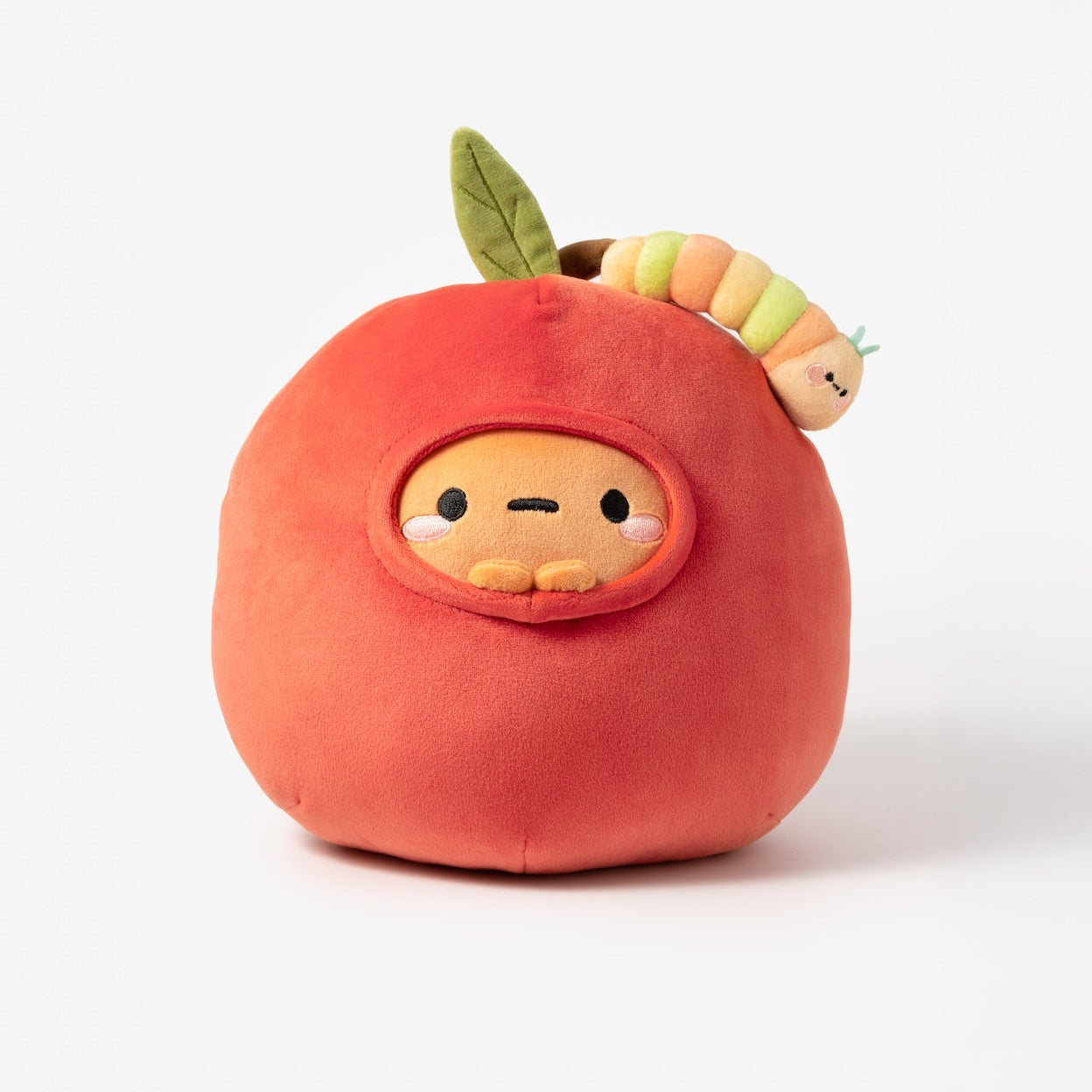 Plush toy shaped like an apple with a small character inside on a white background