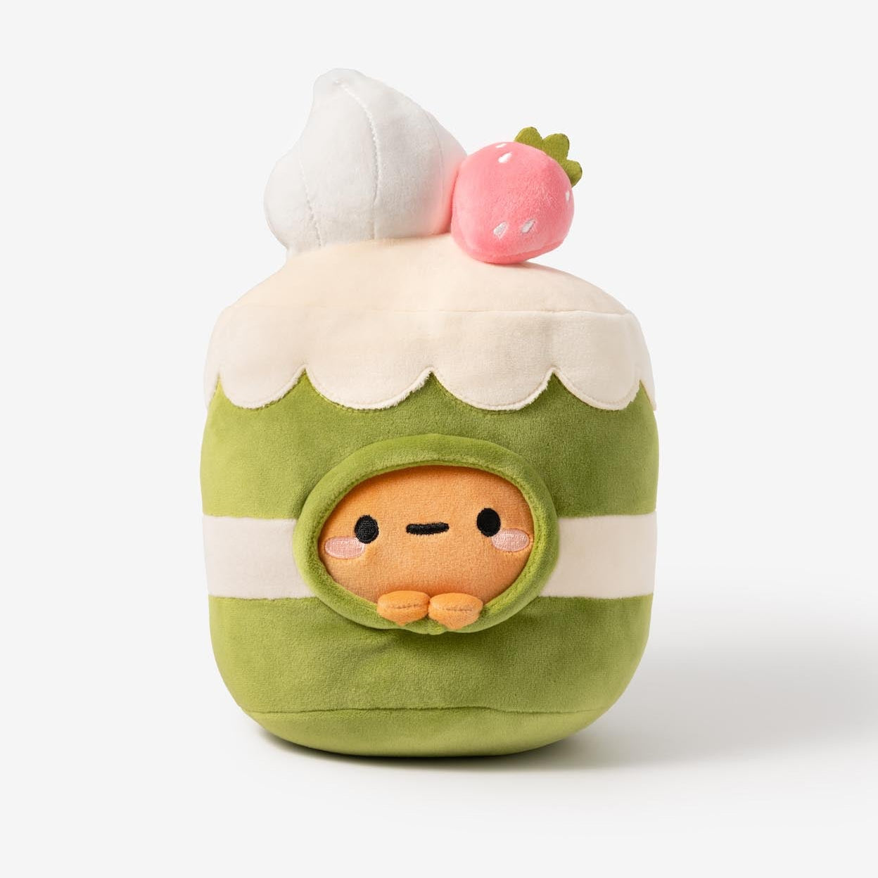 Plush toy resembling a character in a green outfit with white cream and pink cherry on top, on a white background.