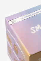 Close up of a box with scissors icon and the words "SURPRISE FIGURE IN" and "COLLECT THEM ALL."