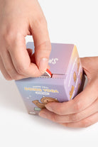 A person opening a Hank Yeti Doing Yoga blind box.