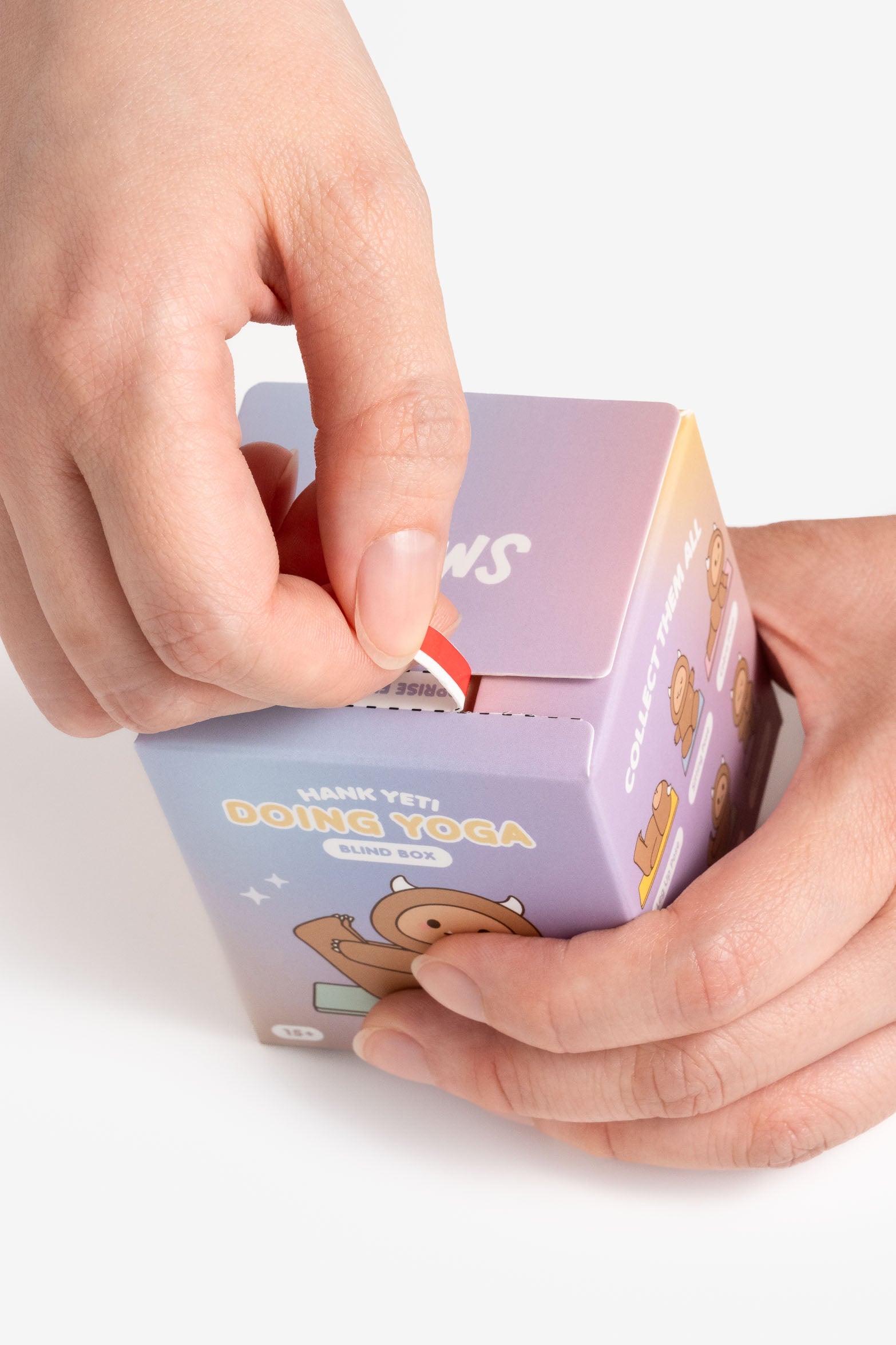 A person opening a Hank Yeti Doing Yoga blind box.