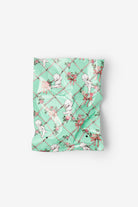 Mint green pouch with fairy design on a white background