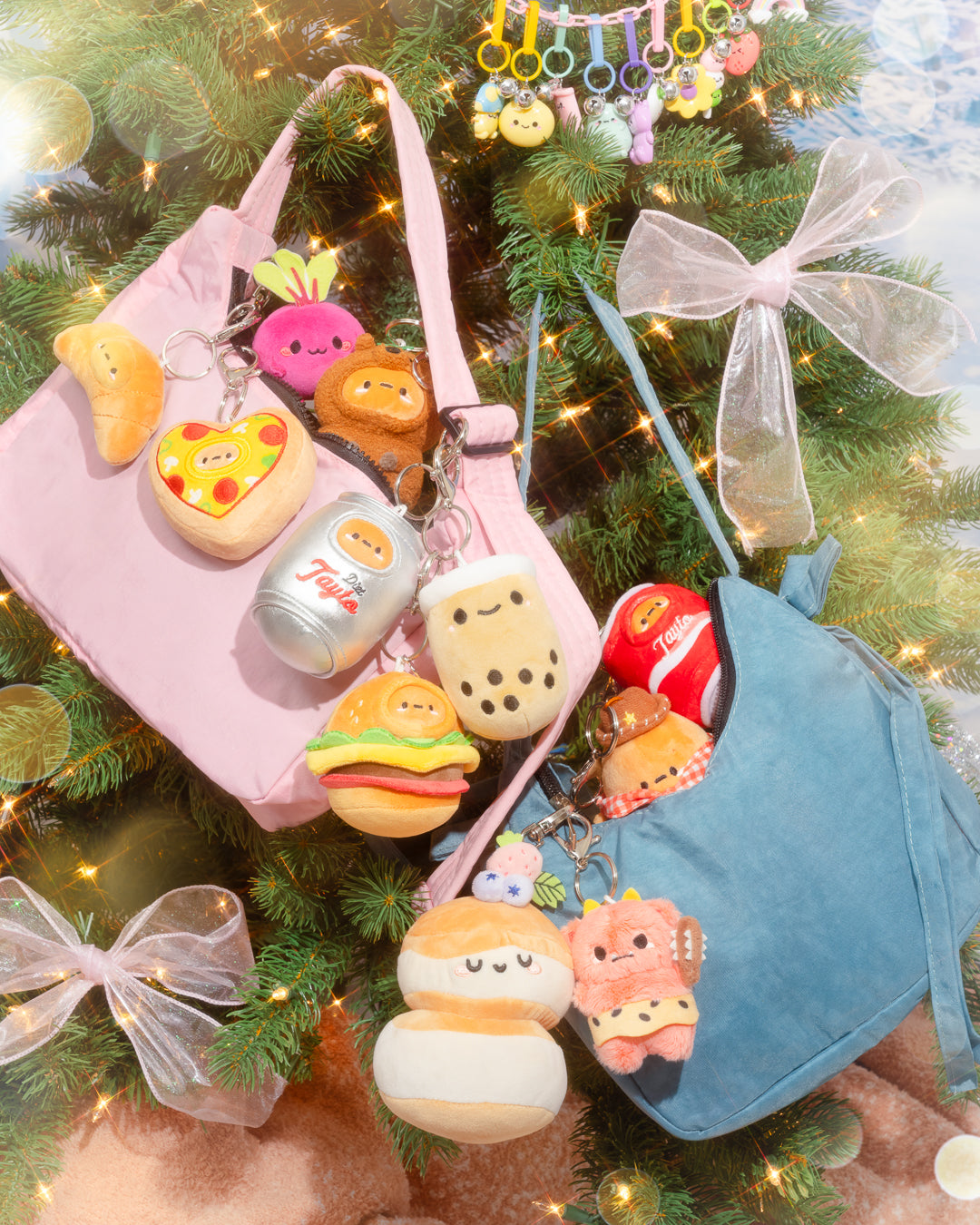 An eye-level close up of two handbags decorated with various food-shaped keychain plushies, under a Christmas tree with clear bows and dangling character keychains.