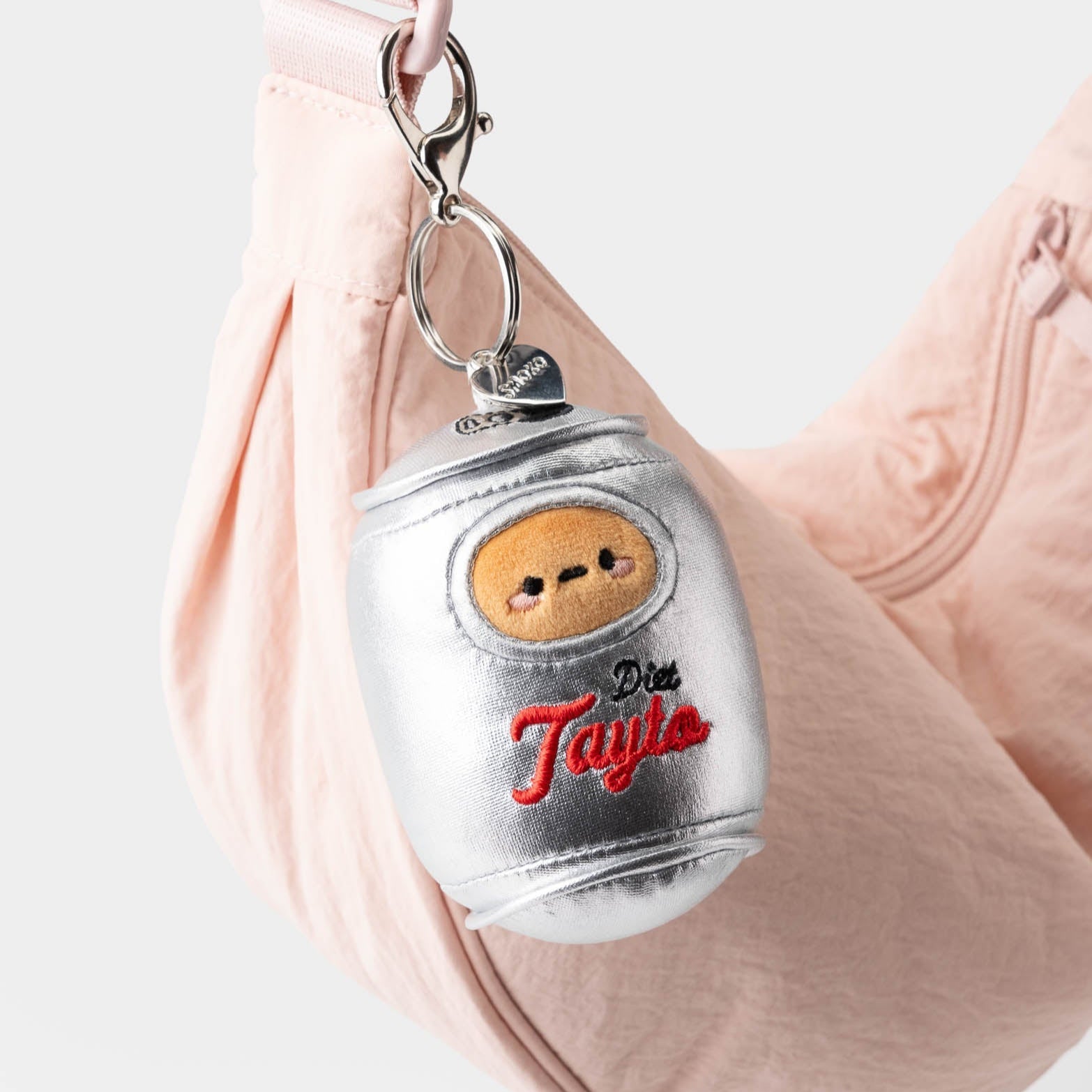 Pink bag with silver Diet Tayto keychain.