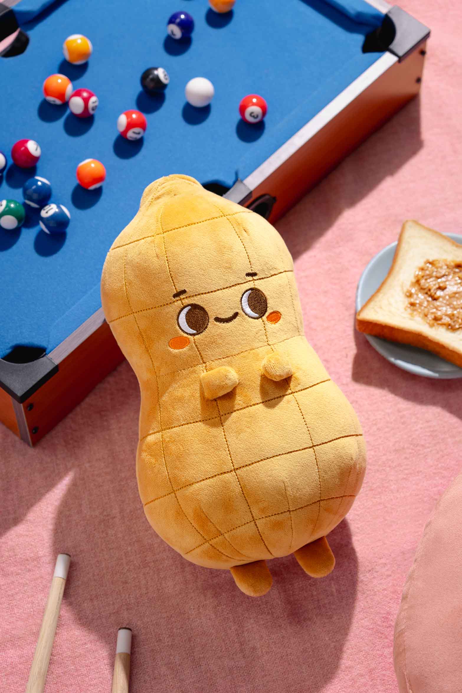 Stuffed peanut toy, pool table, peanut butter toast.