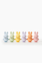 Five pastel-colored Miffy figurines standing in a row on a white background.